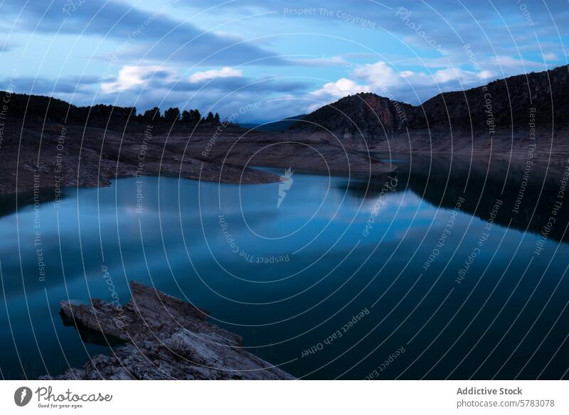 Tranquil dusk scene at a serene mountain lake reflection twilight calm moody sky rocky outcrop blue tranquil water nature landscape peace outdoor scenery