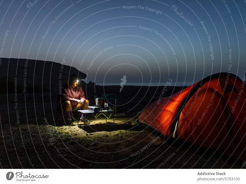 Solo female camper with head torch enjoys night in Fuerteventura woman camping tent fuerteventura canary island spain relax wilderness tranquility outdoor