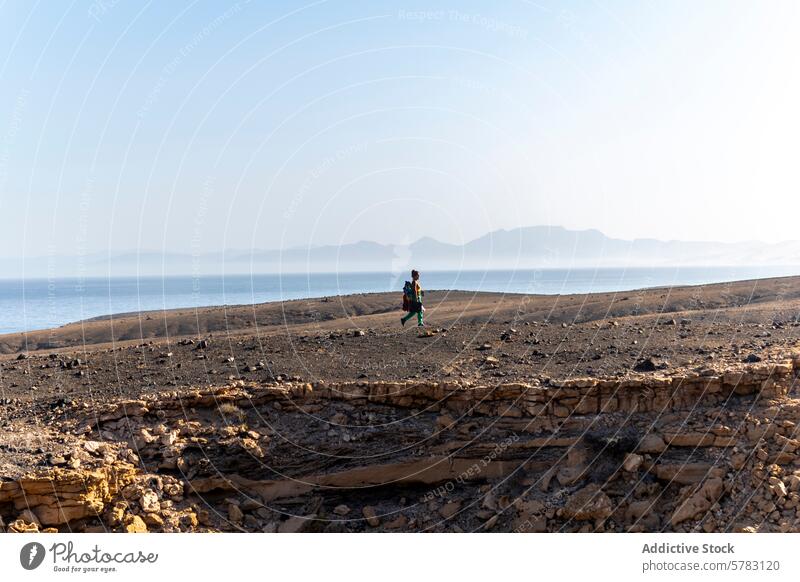 Hiker exploring Fuerteventura's rugged terrain fuerteventura hiking woman camping canary island spain ocean mountain landscape arid travel adventure outdoor