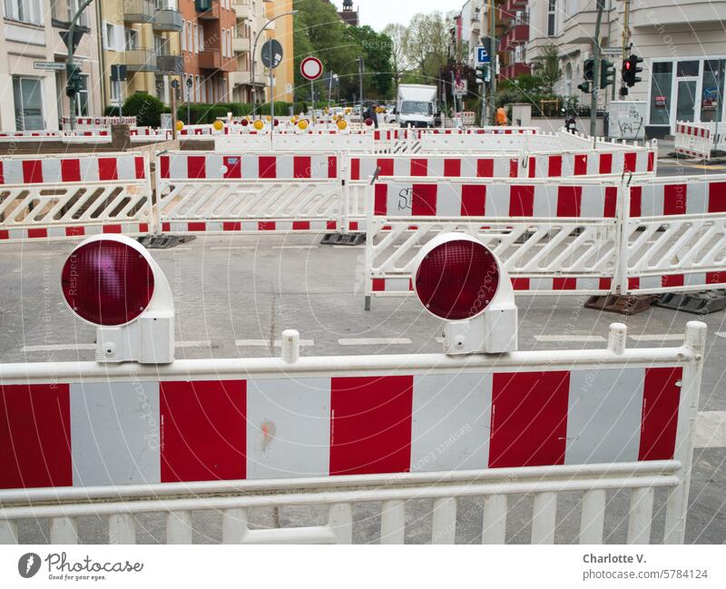 Street scene with many barrier fences. Very many! cordon blocking road closure road blockade Warning lights Barrier warning lights No through road no escape