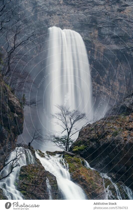 Mighty waterfall at Rio Mundo's source, serene natural beauty rio mundo nature landscape cascade reventón mist greenery rock powerful lush castile-la mancha