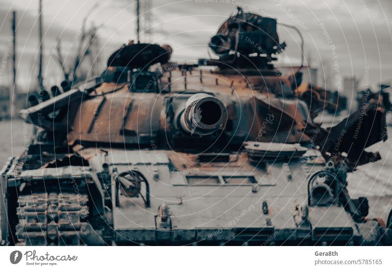 damaged military tank on a city street in Ukraine Donetsk Kherson Lugansk Mariupol Russia Zaporozhye abandon abandoned armor attack bakhmut blown up bombardment