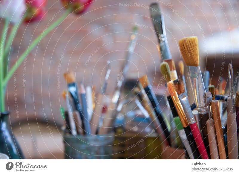 Art and craft tools close up view .   Colorful array of paintbrushes and paints abstract acrylic art artist artistic children colors colourful colours crayons