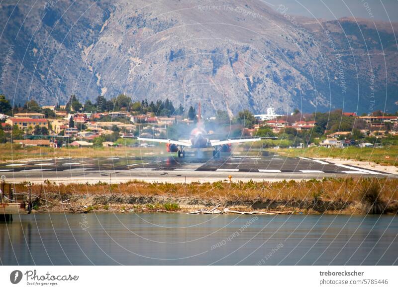 Airplane touching down on the runway, corfu airport, greece aircraft flight tourism speed engine transport transportation fly landing airplane travel gear