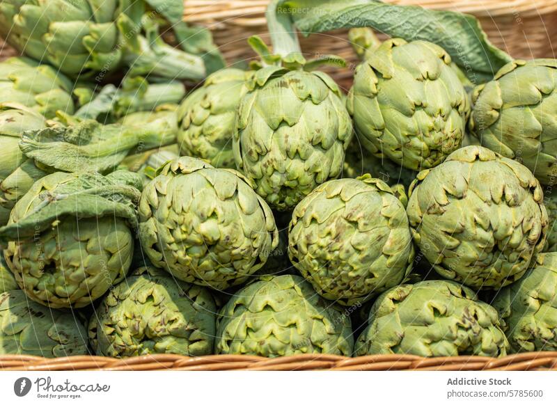 Fresh artichokes in a basket at a farmers market green vegetable fresh food produce healthy organic agriculture farming vegetarian vegan diet nutrition edible