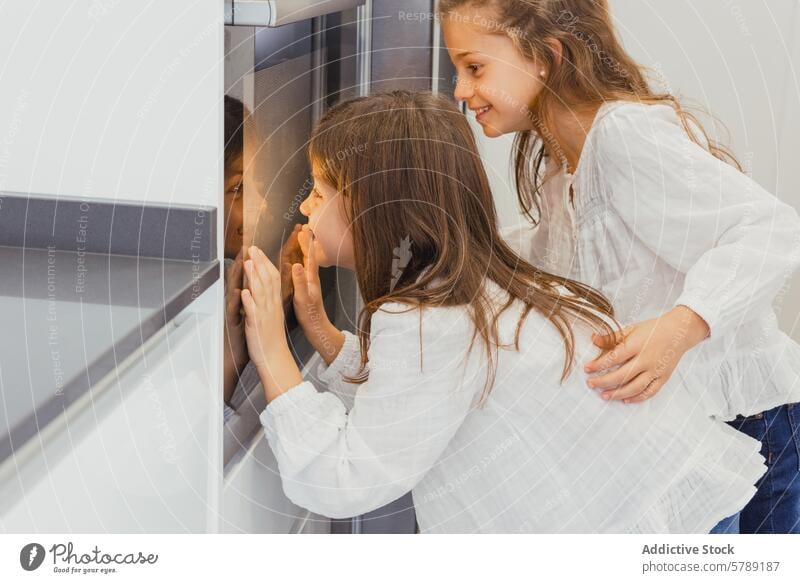 Children peeking at roast chicken in oven child girl family cooking vegetable kitchen excitement anticipation bonding togetherness home indoor meal preparation