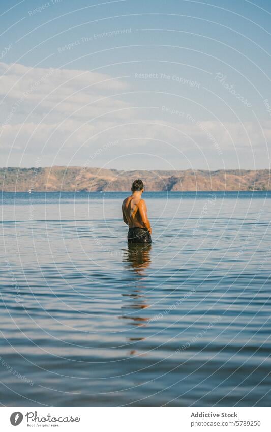 Man enjoying serene waters in Costa Rica man serenity costa rica hills calm peace solitude wading tranquil scene scenic background tranquility nature outdoor