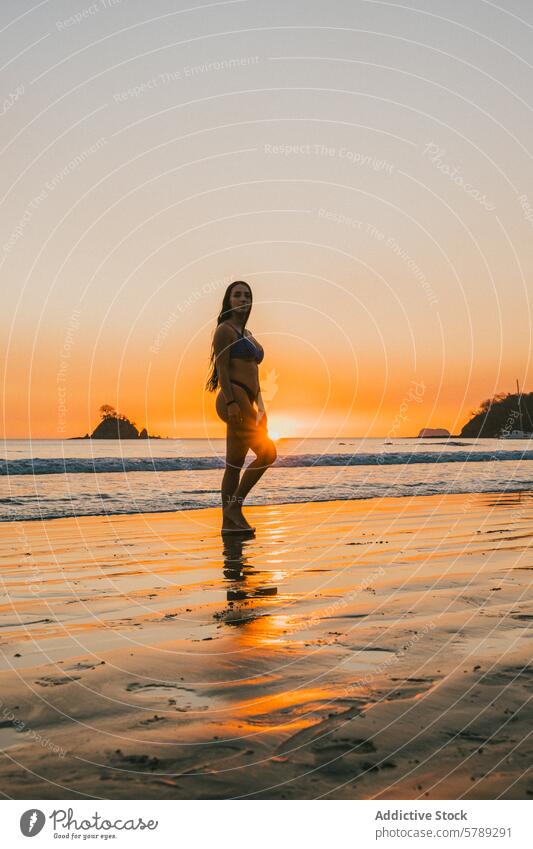 Serene Sunset Silhouette on Costa Rican Beach woman silhouette sunset beach costa rica tranquility natural beauty peace sand ocean evening sky reflection travel