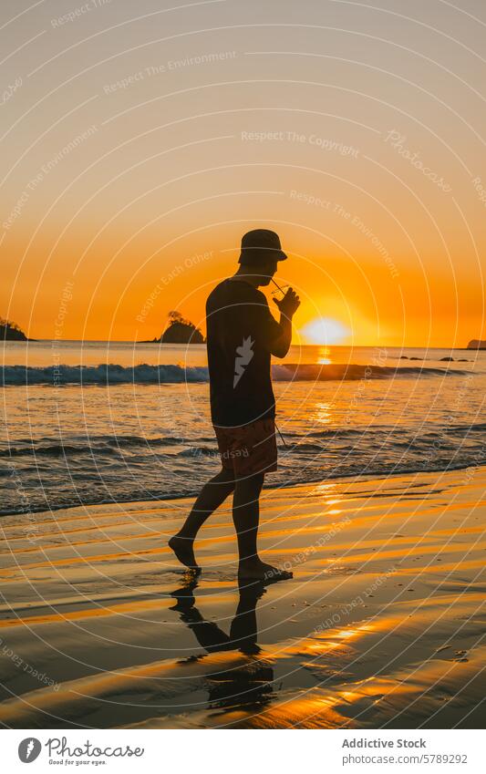 Serene sunset stroll on a Costa Rican beach walk silhouette reflection water costa rica serene tranquility shore coast golden hour seascape travel tourism ocean