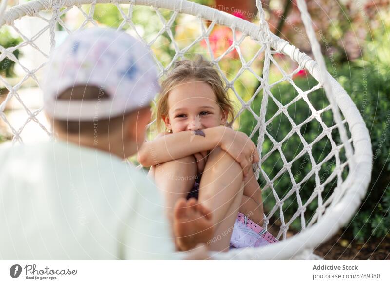 Joyful siblings playing on a swing in the countryside fun sunny silly face laughter joy girl smile engaging playful heartwarming sharing young outside childhood