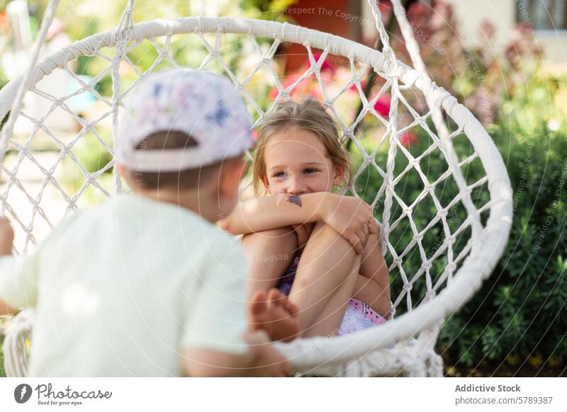 Joyful siblings playing on a swing in the countryside child garden joy fun happiness cheerful sunny day outdoors moment green warmth young engaging sharing