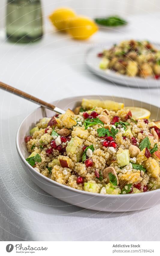 Fresh quinoa salad with curry flavors in a bowl food healthy vegetarian vegan side view ingredients colorful fresh pomegranate avocado lemon chickpeas nuts