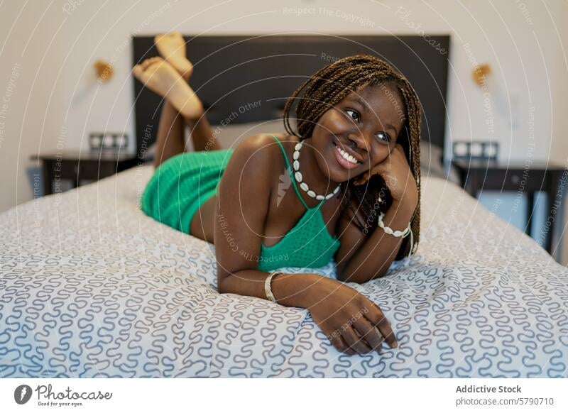 Relaxed African American Woman Enjoying Time at Home woman african american black relaxed home bedroom lying happy smiling casual lifestyle comfort leisure