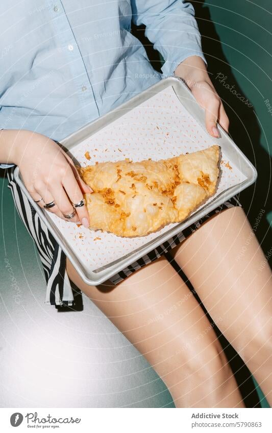 Homemade Cheburek on Baking Sheet Held by Woman woman baking sheet cheburek baked cheese crispy golden-brown homemade meal snack cooking pastry veal tomato