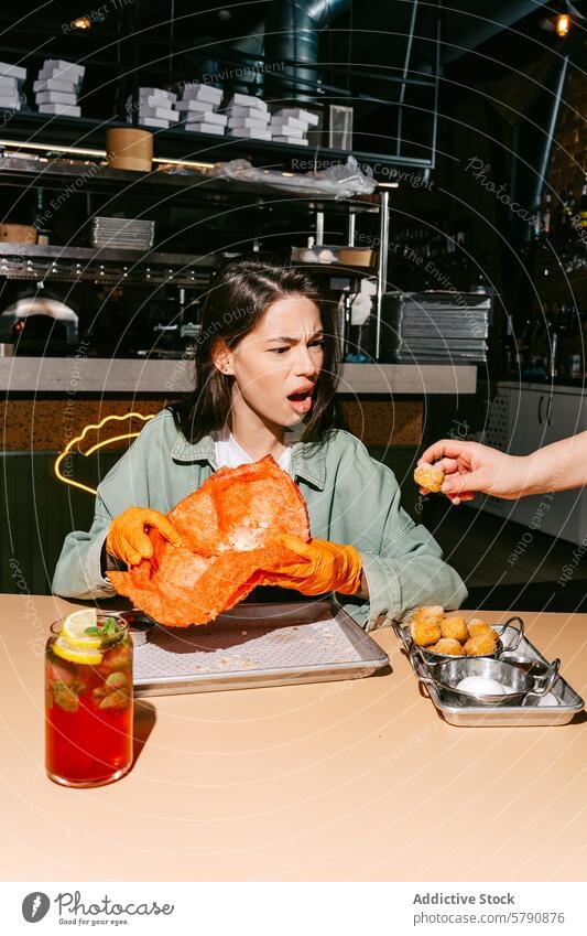 Surprised Woman Eating Giant Cheburek and Enjoying a Drink woman eating giant cheburek crunchy balls berry mojito surprised eatery modern food drink refreshing