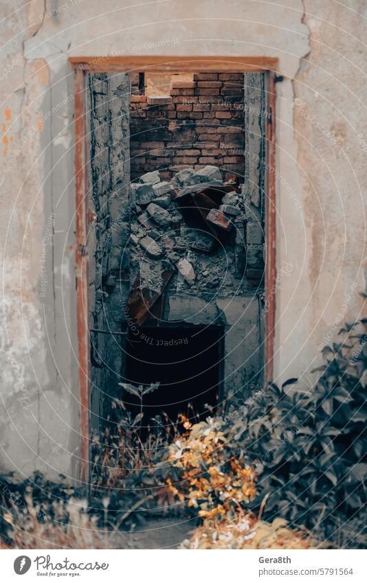 old broken door of a destroyed house in Ukraine access architecture background brown building buried city close color conflict design dirty door handle