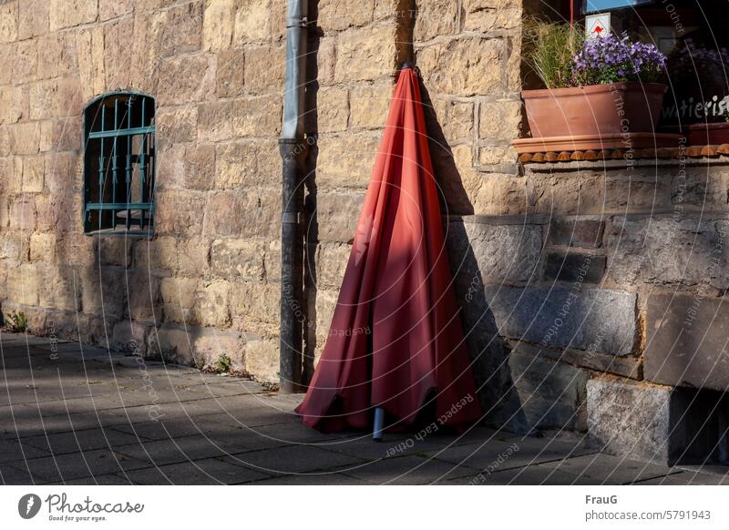 Parasol in partial shade old masonry Masonry Facade Old Building Historic Cuboid big stones Stone Window Grating Downspout dented Window box Grass flowers