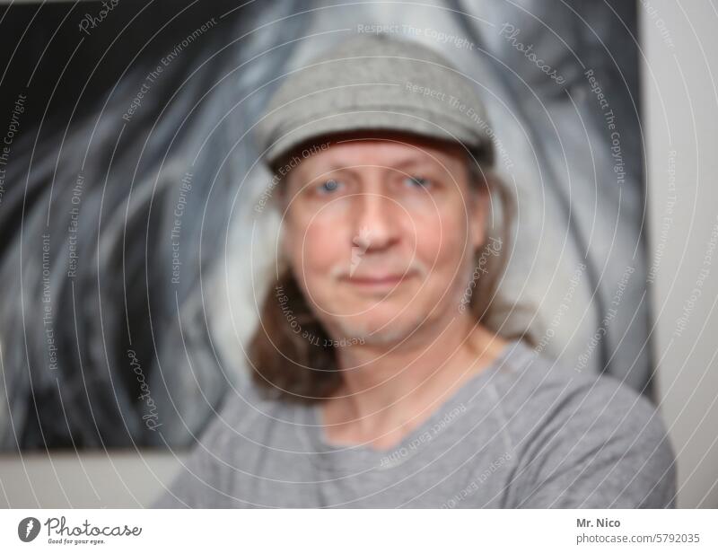 Everything that starts with Un I Unsharp portrait blurred Face Cap Gray Looking into the camera hazy Anonymous Skeptical Authentic Observe Identity Unidentified