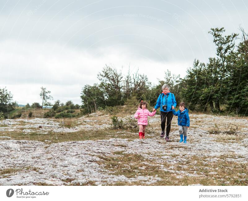 Grandparents with grandchildren enjoying a nature walk grandparent grandson granddaughter family leisure landscape bonding togetherness outdoor activity boy