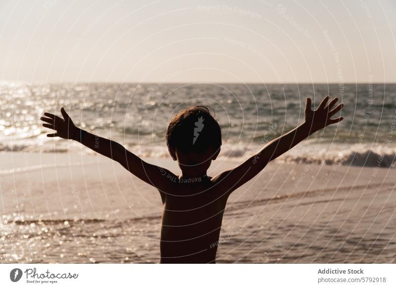 Cchild embracing the sun at a French beach silhouette sea sunset joy freedom sand ocean summer vacation travel france landes coastal nature outdoor sunlight