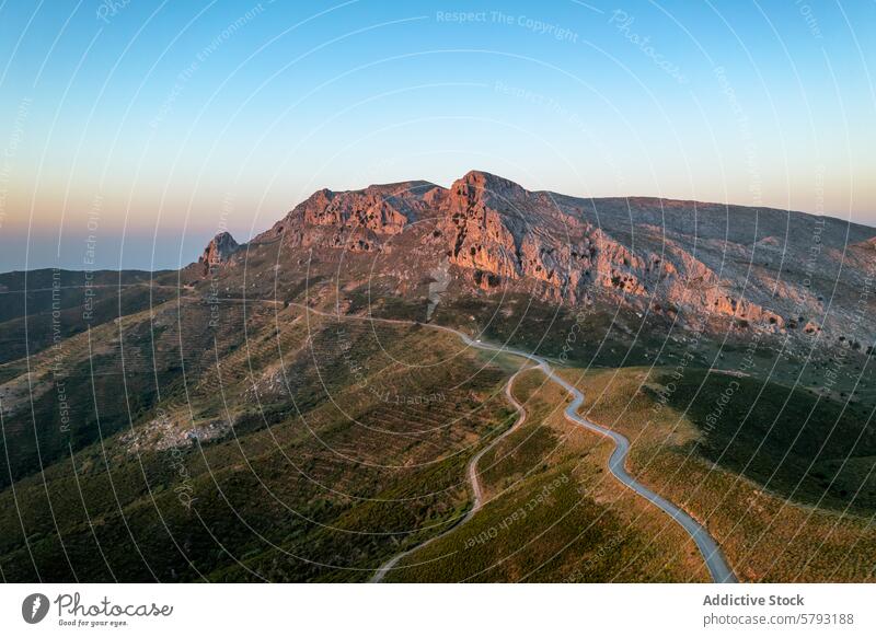 Sardinian mountain landscape at dusk sardinia italy road winding terrain sunset warm hue rugged natural beauty travel tourism outdoor adventure scenic serene