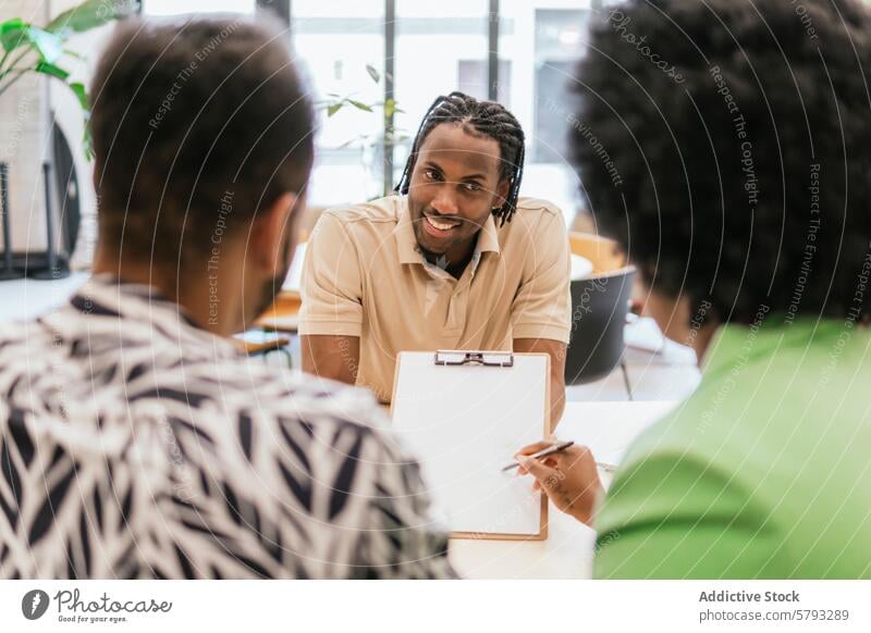 Collaborative teamwork in a modern co-working space meeting collaboration office discussion business plant cheerful man colleague engagement conversation