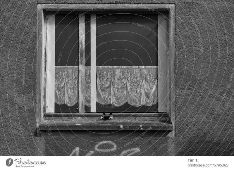 A window with a curtain print ironworks town b/w Window b/w photography Black & white photo B/W B&W Day Deserted Exterior shot Calm Architecture Loneliness