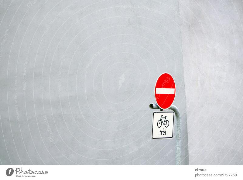 Traffic sign - No entry - and additional sign - Cyclists free - on a metal pole in front of a building Prohibition of entry Road sign VZ 267 Special use signs