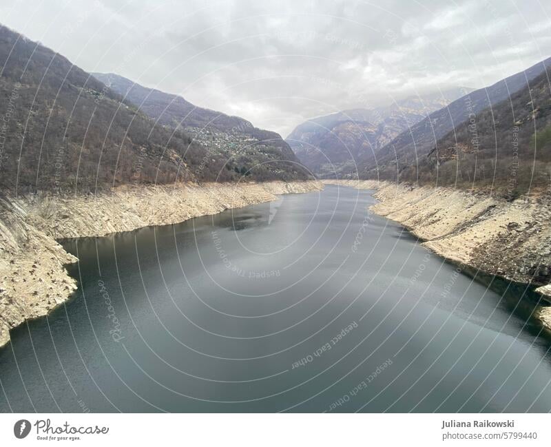 Evaporating reservoir in Switzerland Valley Mountain Sky Clouds Landscape Nature mountains Rock Summer Tourism Environment Day Alps Reservoir Lake Dam panorama