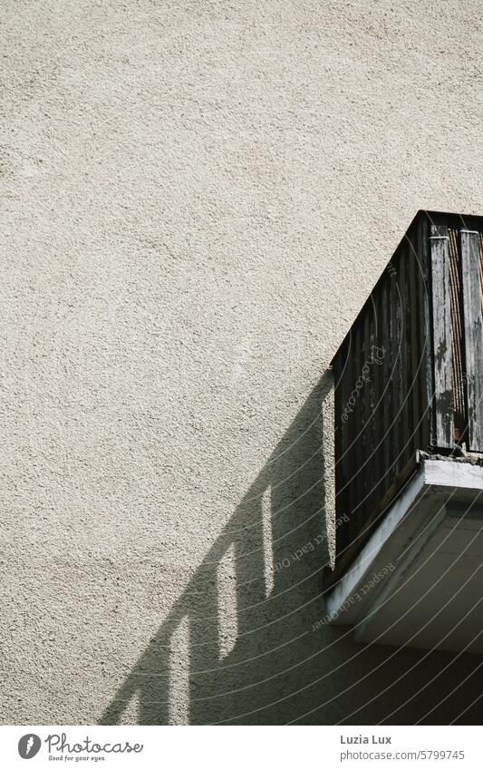 An old, weathered balcony casts a long shadow Balcony Old Weathered Architecture Building Facade Town Wall (building) Gloomy Light sunshine sunny Shadow shady