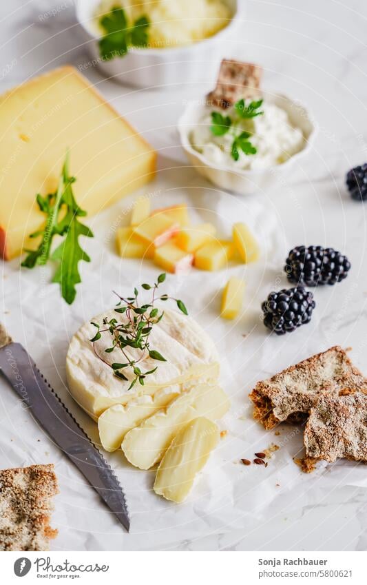 Various cheeses and crispbread on white paper Cheese Crispbread Breakfast Vegetarian diet Organic produce Food Nutrition Protein Delicious Colour photo Bread