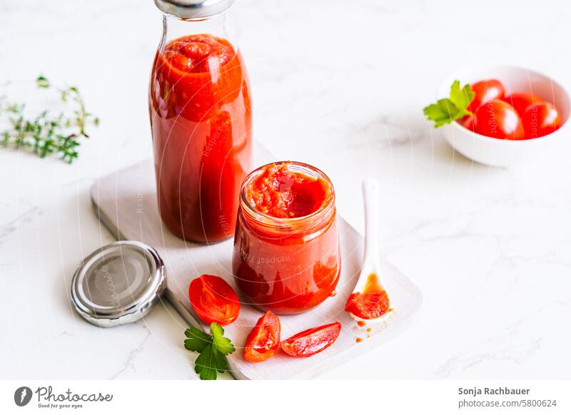 Strained tomatoes in a preserving jar on a white table Tomato mashed Tomato sauce Preserving jar Ketchup Self-made Stability Food Vegetable Delicious Fresh Red