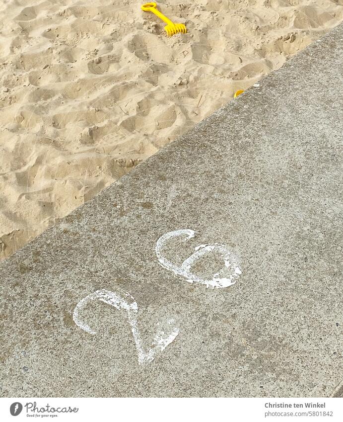 a small yellow rake lies in the sand at beach section 26 Sand toys Children's game Sandy beach Digits and numbers Beach section Lanes & trails Pattern