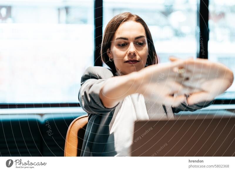 tired businesswoman sitting in front of laptop in an office working entrepreneur professional manager online coworker business person businessperson management