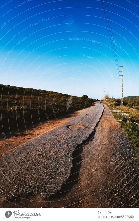 Country damaged road against the full blue sky countryside Country life Country road country love country roads country side Damage Damaged Roadside road trip