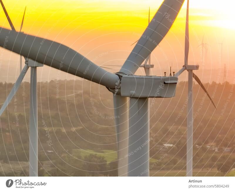 Wind farm field and sunset sky. Wind power. Sustainable, renewable energy. Wind turbines generate electricity. Sustainable development. Green technology for energy sustainability. Eco-friendly energy.