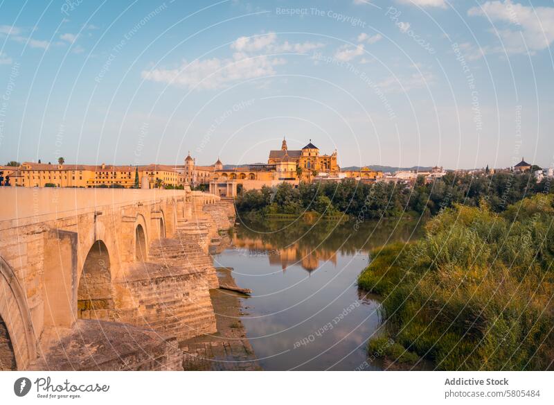 Roman Bridge and Mezquita Cathedral of Cordoba at Sunset cordoba roman bridge mezquita cathedral sunset spain historic river reflection architecture cultural