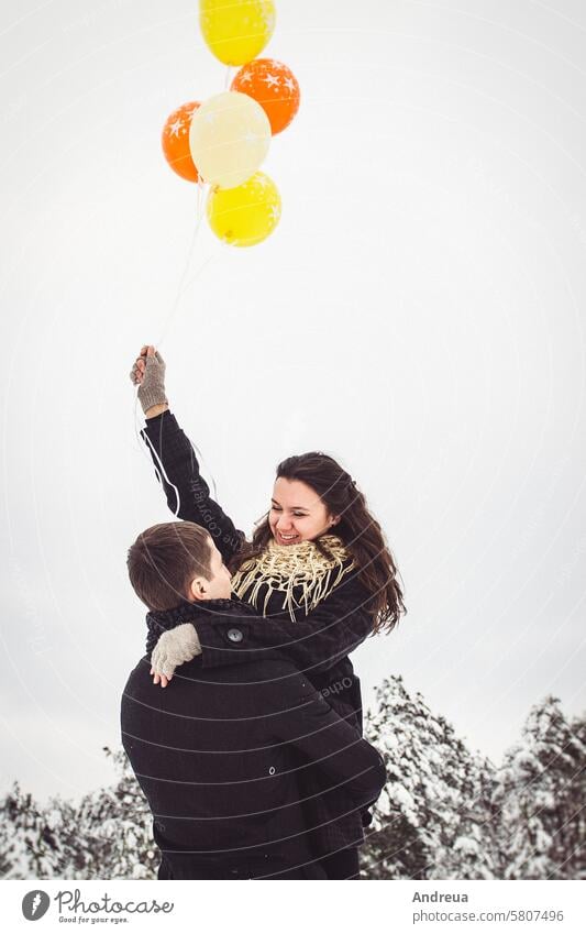 A guy and a girl in warm clothes and scarves on a walk in the snowy weather black coat cold fall field nature new year romance scarf together wet white winter