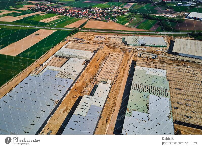 Construction site with steel frame structure of warehouse building, aerial view storage construction logistic storehouse roof infrastructure assembly