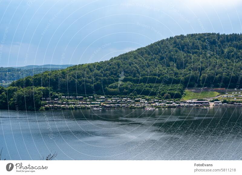 View of the Lake Edersee with a campsite camping caravan water Germany day lake background trees sky Ederstausee Europe pitch Camping copy space landscape