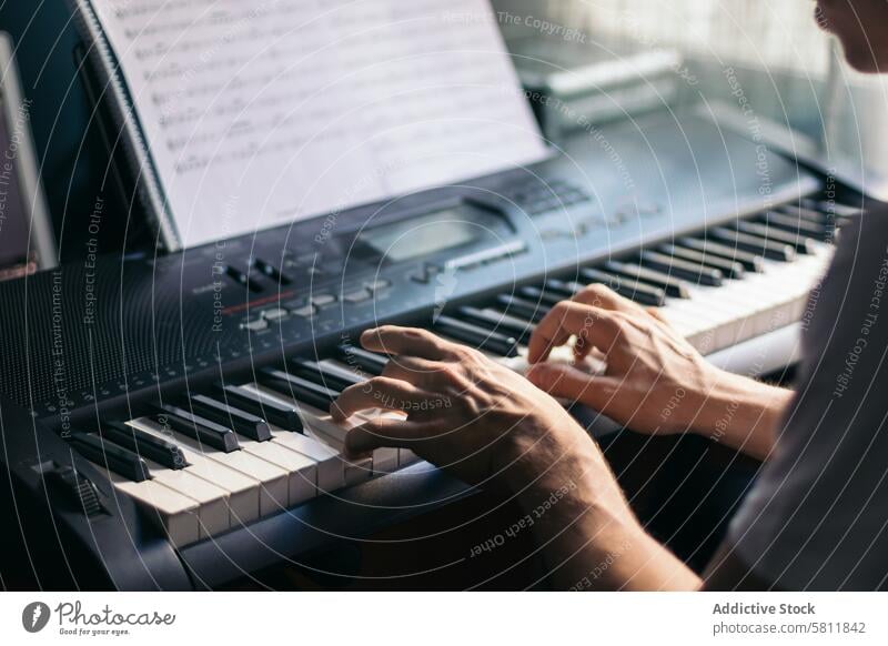 man playing piano with a music sheet instrument musician pianist black melody classic sound performance concert classical jazz entertainment person artist male