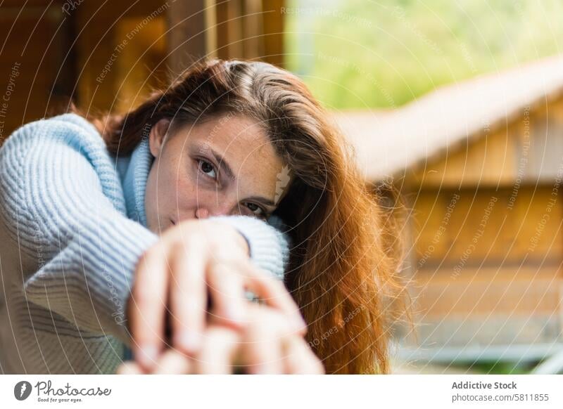 Serene woman relaxing on terrace of house in countryside chill vacation travel traveler serene peaceful enjoy female pyrenees calm wooden idyllic harmony