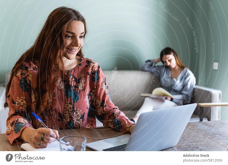 Focused woman taking notes and working on laptop women take note focus busy concentrate write cowork using read student notebook netbook device study browsing