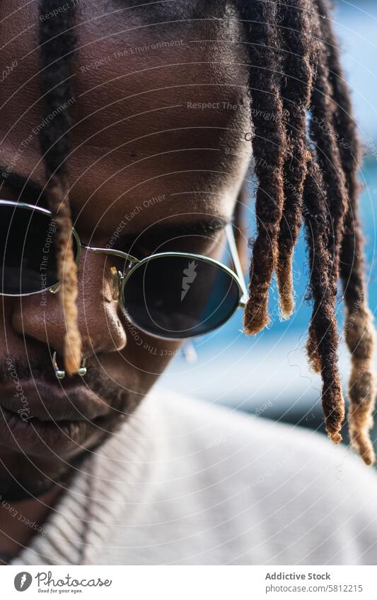 Cool black guy with dreadlocks in city center man cool informal urban street lifestyle confident trendy street style appearance posture cityscape culture casual