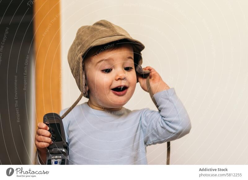 adorable baby with a hat playing with a mobile cute child childhood kid fun happy white boy portrait little caucasian toddler young happiness infant family