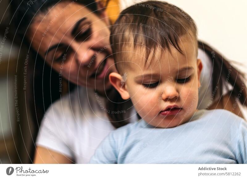 mother playing with her baby sitting at home child parent family kid happy cute woman little toddler mom childhood love people lifestyle together young cheerful