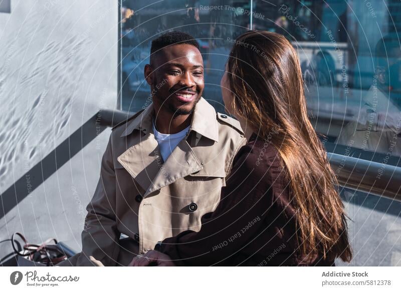 Romantic multiracial couple sitting on bus stop love romantic style together urban relationship affection happy multiethnic diverse african american black