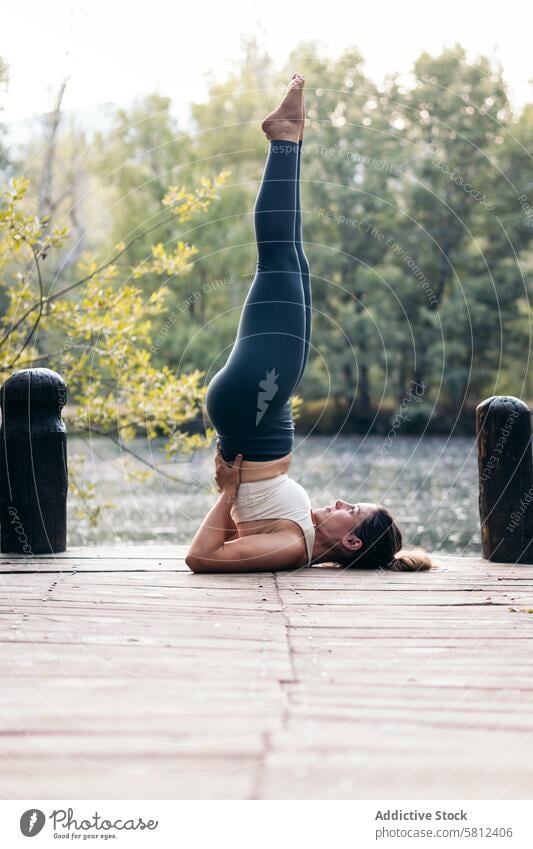 woman in sportswear doing yoga in nature near a lake healthy exercise lifestyle fitness body workout caucasian training pilates young wellness activity active