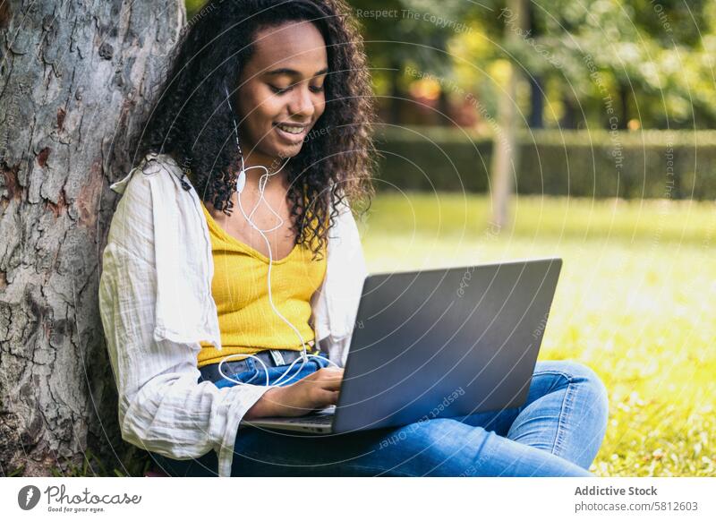 College student working with laptop on campus education college university learning school computer female sitting technology young happy study people studying