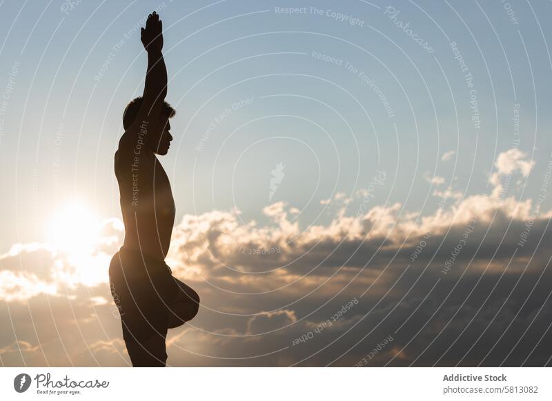 Man practicing yoga asana at sunset man tree pose vriksasana silhouette practice balance harmony zen stand male lifestyle wellness wellbeing vitality healthy